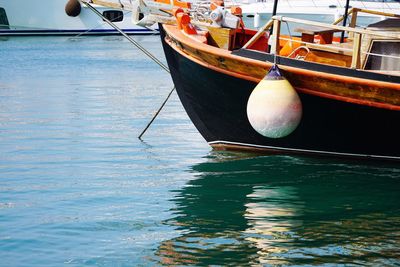 Close-up of sailboats moored in harbor