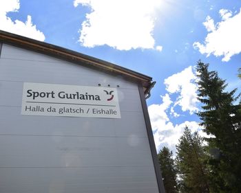 Low angle view of information sign against sky