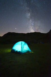 Tent on field against sky at night