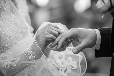 Midsection of couple having engagement ceremony