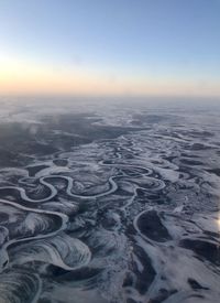 Aerial view of landscape against clear sky during sunset