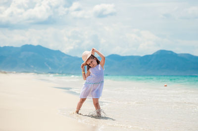 Man standing on beach against sky