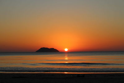 Scenic view of sea against romantic sky at sunset