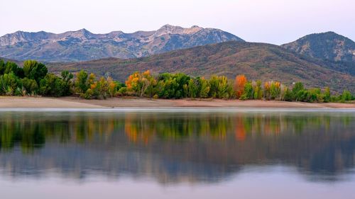 Scenic view of lake and mountains against sky