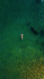 Aerial view of woman swimming in sea