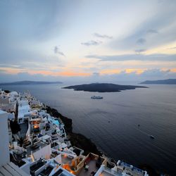 High angle view of town by sea against sky