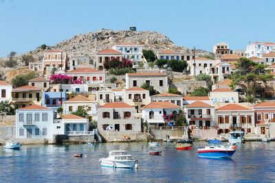 Boats in river with houses in background