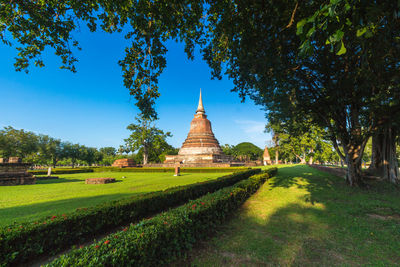 View of temple on landscape against sky