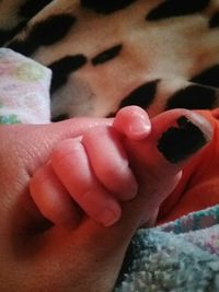 Close-up of baby holding hands