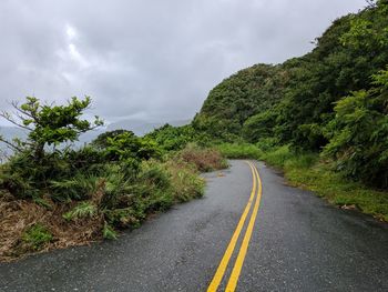 Road amidst trees against sky