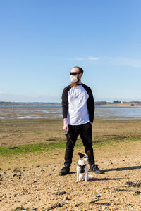 Full length of young man standing on beach