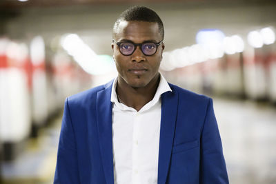 Portrait of young businessman wearing blue suit jacket