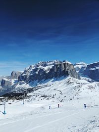 Scenic view of snowcapped mountains against blue sky