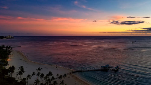 Scenic view of beach against sky during sunset