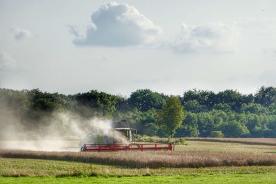 Tractor on field against sky