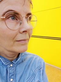 Close-up of thoughtful mature woman looking away while wearing eyeglasses