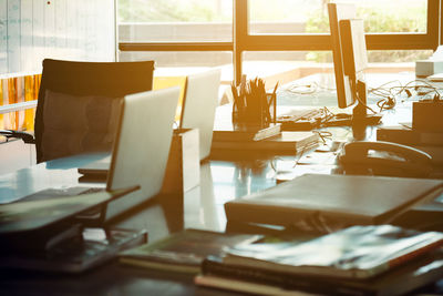 Laptops with office supply on desk in modern office