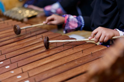 Close-up of hands playing the xylophone