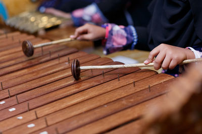 Close-up of hands playing the xylophone
