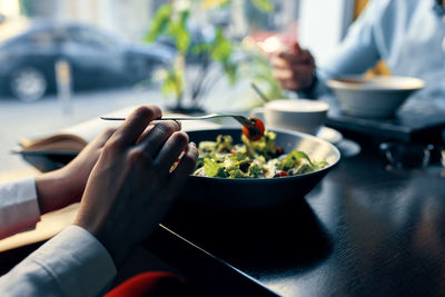 Midsection of person preparing food on table
