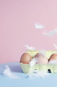 Close-up of eggs in carton on table