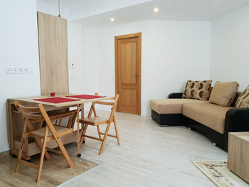 Empty chairs and table against wall at home