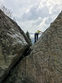 Rear view of man climbing mountain