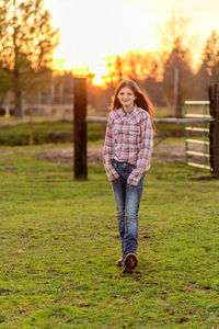 Portrait of woman walking on field