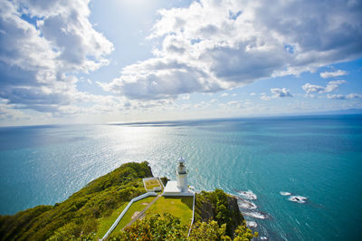 Rear view of lighthouse on sea against sky