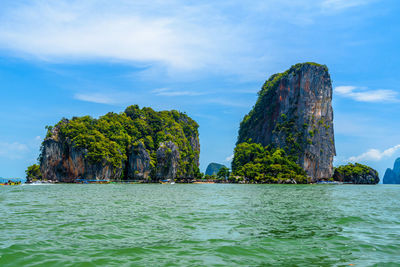 Rock formations in sea against sky