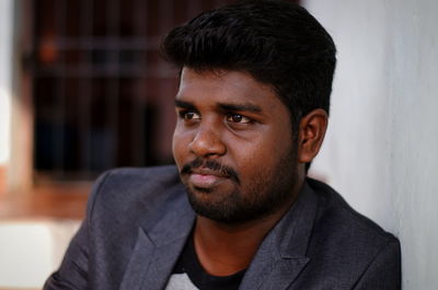 Close-up of smiling man looking away