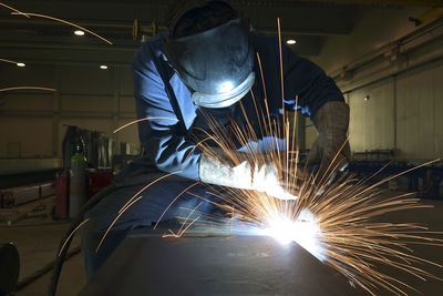 Low angle view of man standing in factory