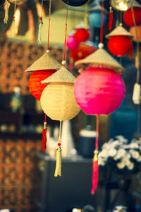 Close-up of red lanterns hanging at market stall