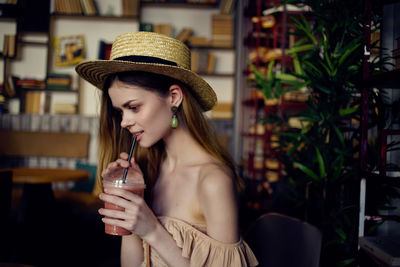 Young woman in drinking glass