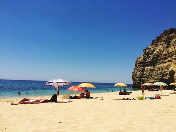 Scenic view of beach against blue sky