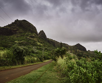 Road by mountain against sky