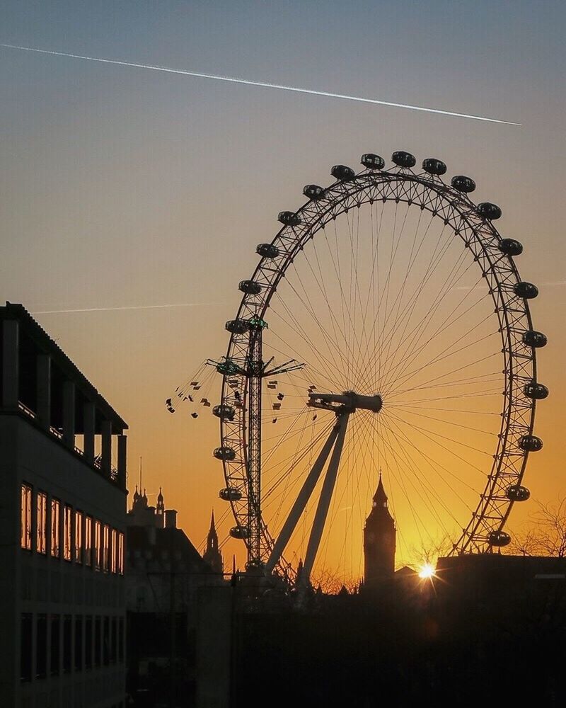 SILHOUETTE FERRIS WHEEL AGAINST SKY