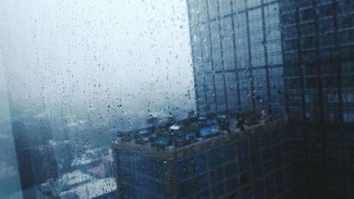 Close-up of wet glass window in rainy season