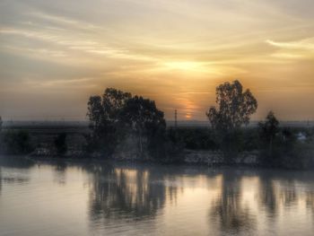 Scenic view of lake against sky during sunset