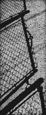 Shadow of person on footpath