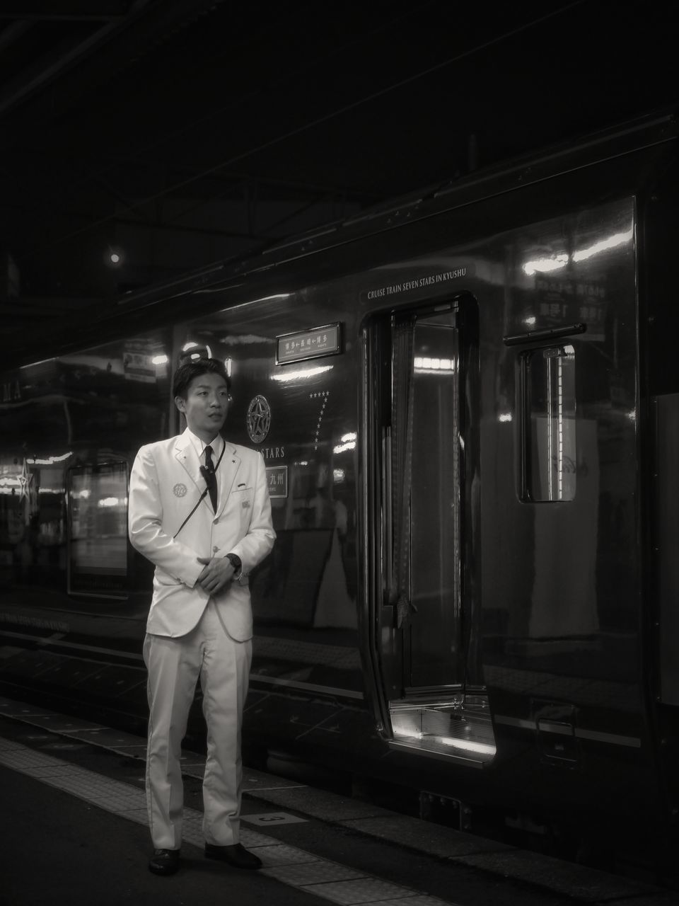 men, lifestyles, rear view, full length, illuminated, night, standing, person, public transportation, indoors, casual clothing, walking, railroad station platform, leisure activity, transportation, railroad station, rail transportation