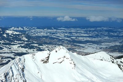 Scenic view of snowcapped mountains against sky