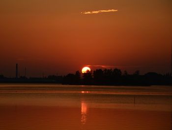 Scenic view of lake against orange sky