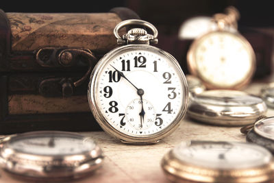 Close-up of pocket watches on table