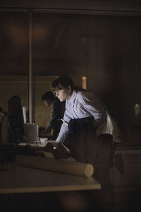 Young businesswoman working on computer last minute at work place