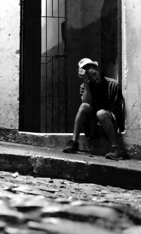 Statue of man sitting by window