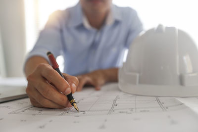 Midsection of man working on table