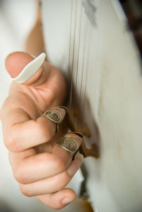 Cropped image of musician playing banjo with fingerpicks