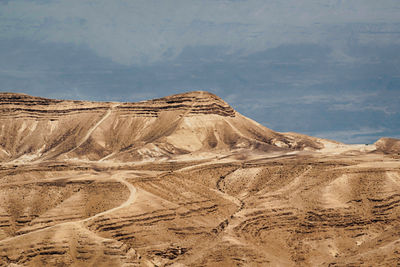 Scenic view of arid landscape against sky