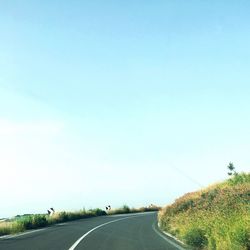 Empty road against clear sky